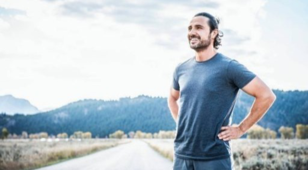 Man standing on road smiling